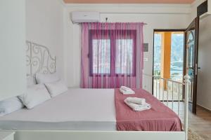 a bedroom with a white bed with a pink window at Apartments Barbara in Kotor