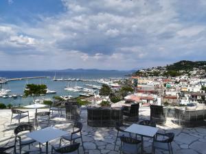 a patio with tables and chairs and a view of a harbor at Hotel Gran Paradiso in Ischia