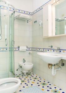 La salle de bains est pourvue d'un lavabo et de toilettes. dans l'établissement Hotel Gran Paradiso, à Ischia