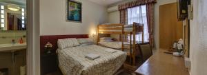 a small bedroom with a bed and a bunk bed at Barry House in London