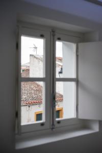 an open window with a view of a building at Évora Art&Accommodation in Évora