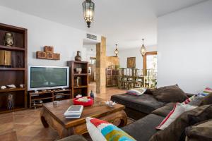 a living room with a couch and a tv at VILLA CALMA en Teguise, "Pueblo con Encanto" in Teguise