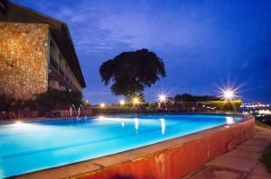 a large swimming pool at night with lights at Cassia Lodge in Munyonyo