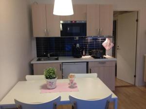 a kitchen with a table with a potted plant on it at Hällestrand Apartment 32 in Strömstad
