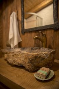 a bathroom with a stone sink and a mirror at Hobití dom in Spišský Štiavnik +33 photos