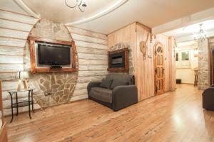 a living room with a couch and a tv on a wall at Apartament Zborowskiego in Zakopane