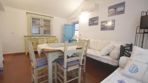 a living room with a table and a couch at Italianflat - Villa Cá Rosa in Porto Rotondo