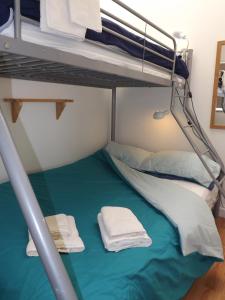 a bunk bed in a room with towels on it at Seagull's Crest in Camber