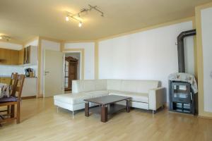 a living room with a white couch and a table at SENITA's Rooms & Apartments in Nin
