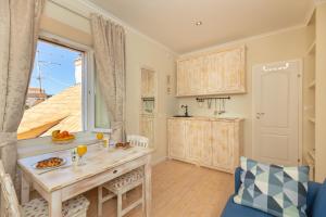 a kitchen with a table and a window at Siesta Ragusa in Dubrovnik