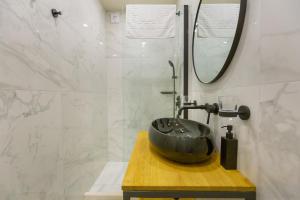a bathroom with a black sink and a mirror at Siesta Ragusa in Dubrovnik +22 photos