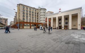 un grupo de personas caminando por la plaza de la ciudad en Hotel Spektr Khamovniki, en Moscú