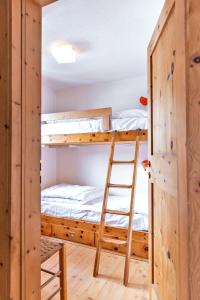 a room with bunk beds and a ladder at Chesa Dal Gial - Celerina in Celerina