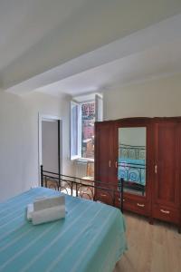 a bedroom with a bed and a dresser and a window at Residenza Sant’ Antonio in Riomaggiore