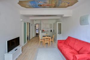 a living room with a red couch and a table at Residenza Sant’ Antonio in Riomaggiore