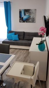 a living room with a couch and a table at Apartament Wałowa Wejherowo in Wejherowo