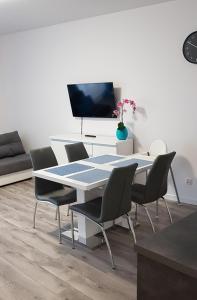 a dining room with a table and chairs at Apartament Wałowa Wejherowo in Wejherowo