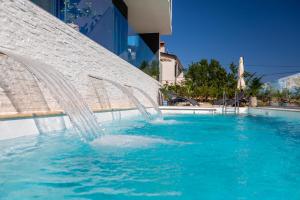 a water fountain in a pool in a building at Villa Valis in Baška