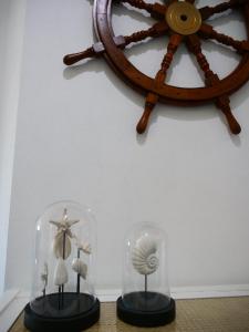 two figurines in glass cases on a table with a wheel at Blue Apartment in Prainha in Alvor