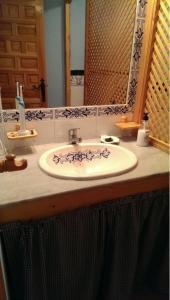 a bathroom counter with a sink and a mirror at BONITO APARTAMENTO EN ZAHARA DE LOS ATUNES in Zahara de los Atunes +16 photos