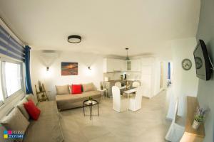 a living room with a couch and a table at Evaggelia Design Suite in Nea Peramos