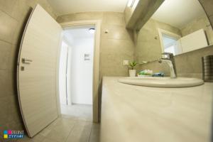 a bathroom with a sink and a mirror at Evaggelia Design Suite in Nea Peramos +36 photos