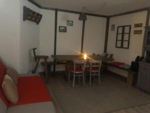uma sala de estar com uma mesa e cadeiras e um sofá em Apartma Romana em Spodnji Otok