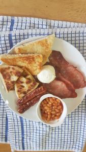a plate of breakfast food with sausage beans and toast at Rockhill hospitality in Coleraine
