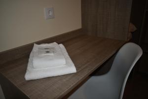 a wooden table with a white towel on top of it at Horta d'Alva in Castelo Branco