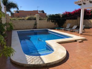 a swimming pool in a backyard with at Casa de la Colina in Torre del Mar