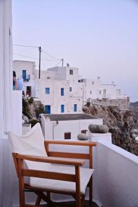 a couple of chairs sitting on top of a building at Stunning town-house in Chora, Serifos in Serifos Chora