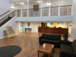 a lobby with two couches and a staircase at Days Inn by Wyndham Columbus IN in Columbus