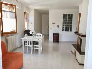 a living room with a white table and chairs at La casa di Lory in Falconara Marittima