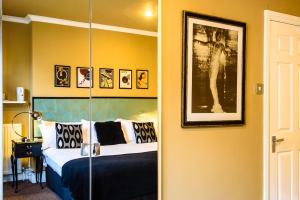 a bedroom with a bed and a picture on the wall at Paskins Town House in Brighton & Hove