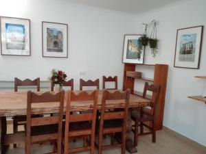 uma sala de jantar com uma mesa de madeira e cadeiras em Guesthouse Alentejo em Évora