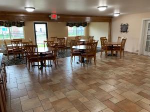 a dining room with wooden tables and chairs at Days Inn by Wyndham Columbus IN in Columbus
