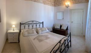una camera con un grande letto e una sedia di Historich house Largo Martellotta 44 ad Alberobello