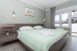 una camera da letto con un letto e due asciugamani di apartman Marin a Trogir
