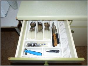 a white drawer with utensils in a table at DDR Bungalow direkt am Strand auf Rügen in Dranske