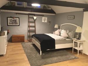 a bedroom with a bed with a ladder in it at Alter Winzerhof in Hatzenport