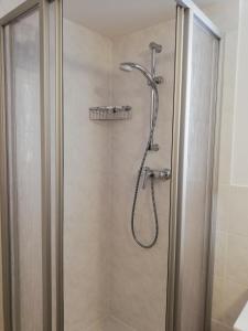 a shower with a shower head in a bathroom at Apartment Haider 2 in Obertraun