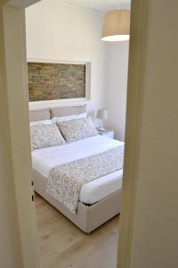 A bed or beds in a room at Modarno Exclusive Apartments