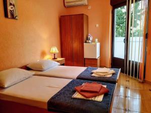 a bedroom with two beds with towels on them at Villa Budvanka Guesthouse in Budva