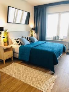 En eller flere senge i et værelse på Aquamarina Onyx Blue