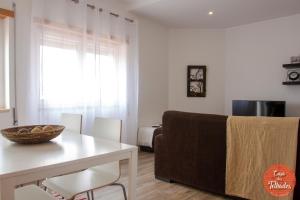 a living room with a table and a couch at Peniche Roof View House - Beach Village in Peniche