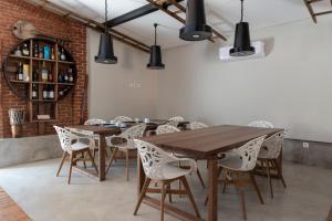 a dining room with wooden tables and white chairs at Quinta do Ragal in Lavacolhos