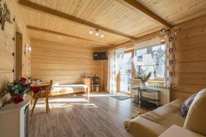 drewniany pokój z łóżkiem i stołem w obiekcie Mazurkowy Gościniec w Zakopanem