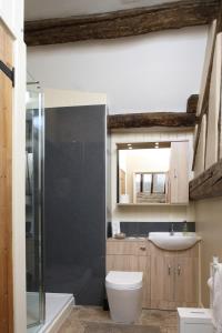 a bathroom with a shower and a toilet and a sink at Eight Bells Inn in Chipping Campden