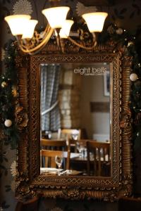 an ornate mirror in a restaurant with a dining room at Eight Bells Inn in Chipping Campden