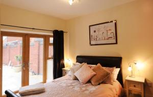 a bedroom with a bed and a glass door at Orchid House in Southport